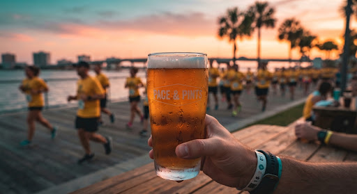 Craft beer pint with runners in the background at sunset
